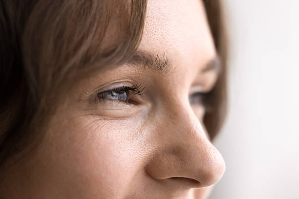 istock Closeup young female face with expressive brown eyes looking away 2245868809