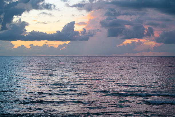 Sea sunset with sky and sun through the clouds over. Ocean and sky background, seascape.