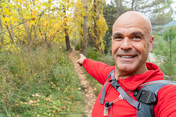 istock Happy man takes a selfie in the forest 2245871566