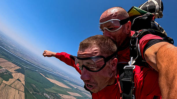 istock Adrenaline filled tandem skydiving selfie during freefall with panoramic earth view from above 2245872297