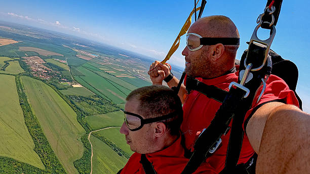 Tandem skydivers capture adrenaline-filled first-person jump with dramatic earth view during freefall