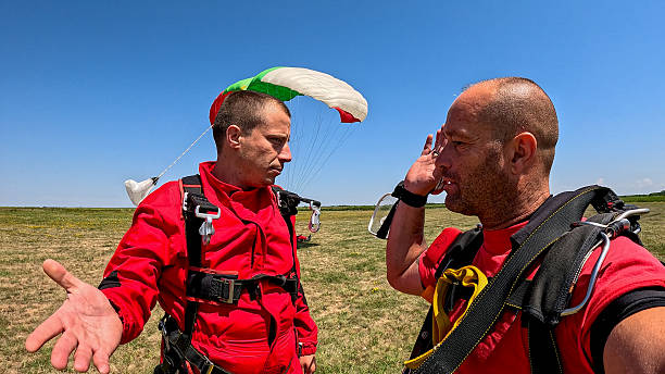 istock Two tandem skydivers in red jumpsuits take a selfie during freefall 2245872303