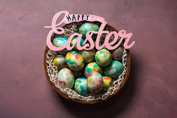 A vibrant arrangement of pastel-colored Easter eggs nestled in a basket, embodying a joyful celebration. The colors and patterns enhance the festive spirit associated with this traditional spring holiday.