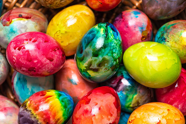 An eye-catching collection of colorful Easter eggs fills a basket, each uniquely designed to reflect joy and creativity. Their vibrant colors and patterns symbolize the celebration of life and renewal during Easter.