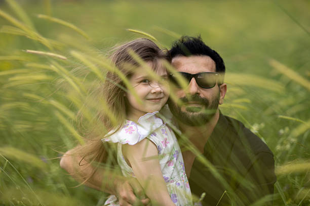 Carefree young father and daughter hugging in spring day.