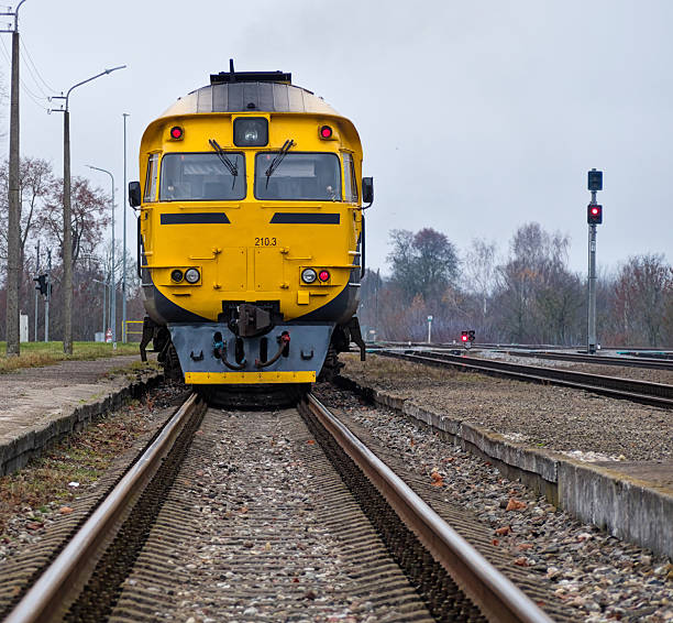 istock Bright Yellow Passenger Train Moving Forward on Railway Tracks 2245878825