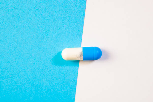 Blue and white pills on a blue and white background. Copy space