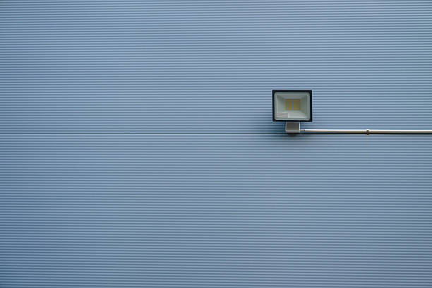 Minimalist outdoor wall lamp on grey background.
