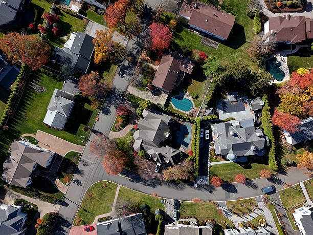 Affluent neighborhood large homes small town, urban sprawl autumn colors.