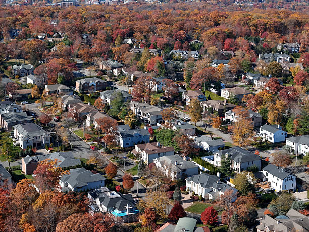 Affluent neighborhood large homes small town, urban sprawl autumn colors.