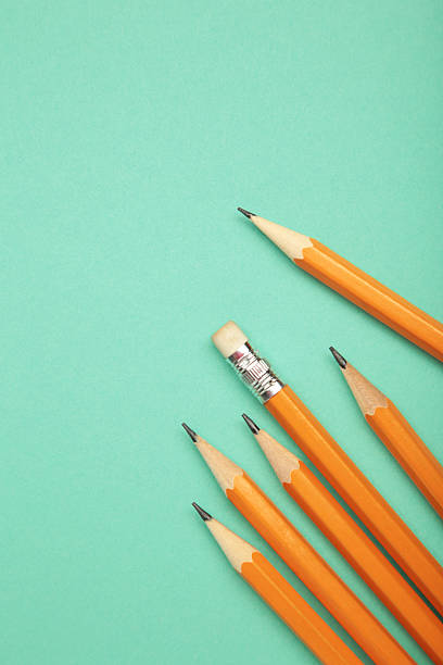 Graphite pencil with eraser on mint background. School stationery. Top view
