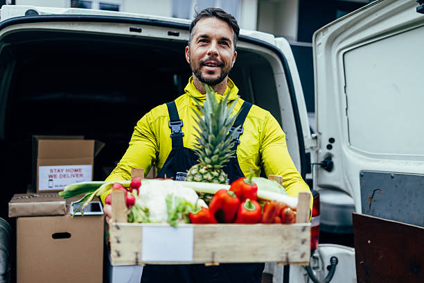 istock Man delivering fresh groceries from delivery van 2245888490