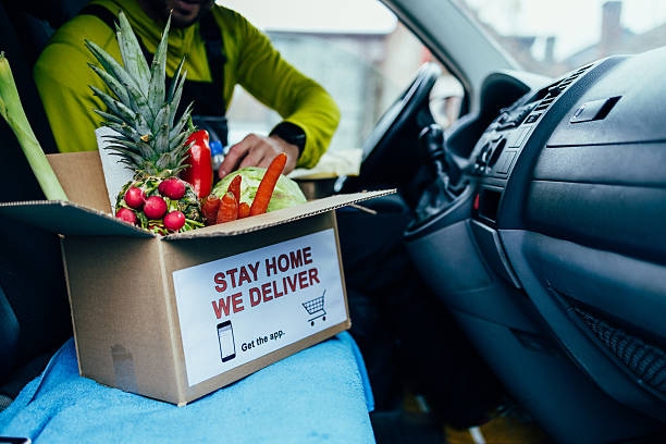 istock Delivery driver packing grocery box for home delivery service 2245888529