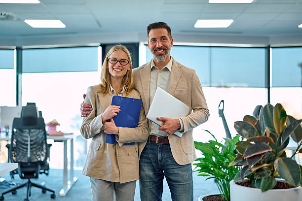 istock Business colleagues standing together in modern office 2245890049