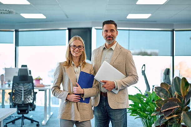 istock Business colleagues standing in modern office ready for work 2245890051