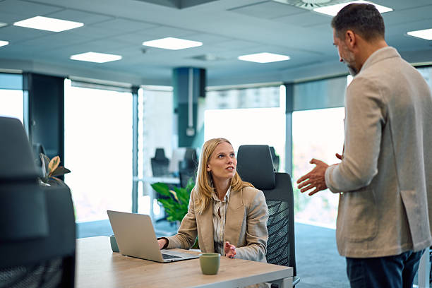 istock Business colleagues discussing work in modern office 2245890091