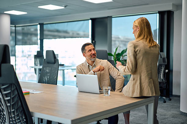 istock Business colleagues talking in modern office meeting room 2245890213