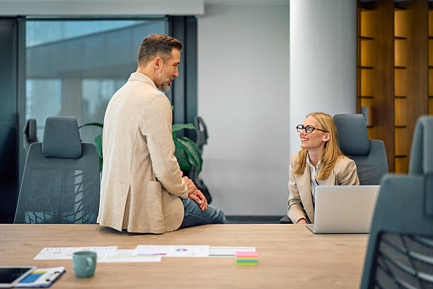 istock Business colleagues talking in modern office workspace 2245890227