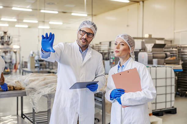 istock Food factory workers inspecting quality control processes 2245891107
