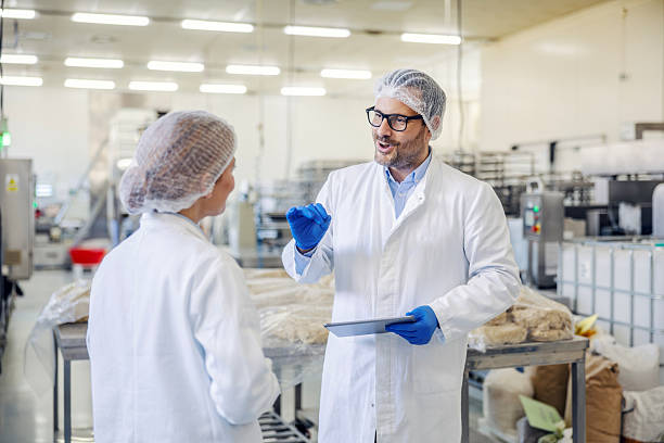 istock Quality control manager discussing production with worker in factory 2245891113
