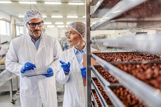 istock Food factory managers inspecting production line using digital tablet 2245891148