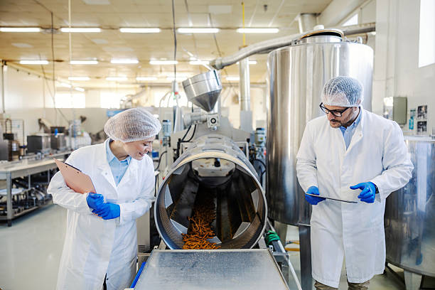 istock Quality control managers inspecting food production line 2245891325