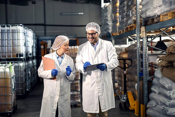 istock Quality control inspectors examining goods in warehouse 2245891460