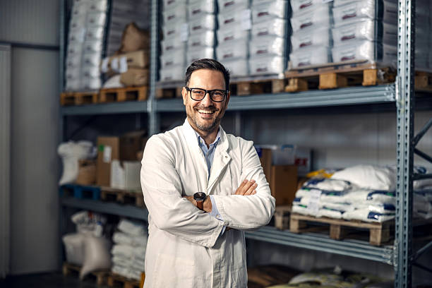 istock Happy man in lab coat working in warehouse 2245891527