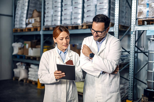 istock Colleagues collaborating on tablet for quality control in warehouse 2245891564