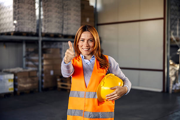 istock Female warehouse worker giving thumbs up gesture 2245892367