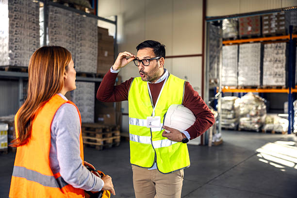 Warehouse workers reacting with surprise and disbelief