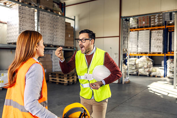istock Supervisor yelling at worker during warehouse conflict 2245892397
