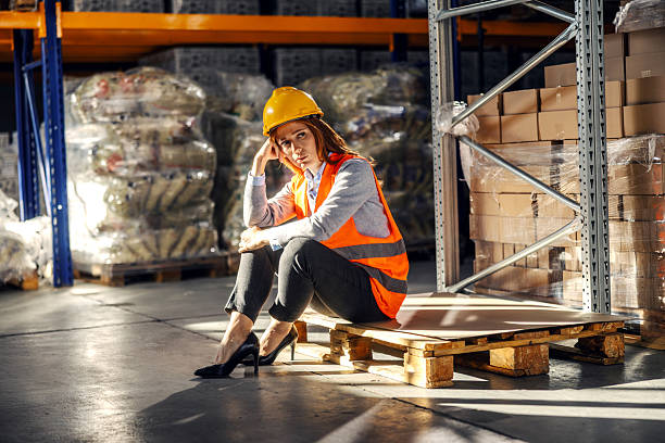 istock Woman experiencing burnout sitting on a pallet in warehouse 2245892437