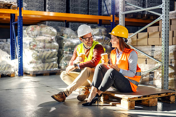 istock Warehouse workers enjoying coffee break in logistics center 2245892465