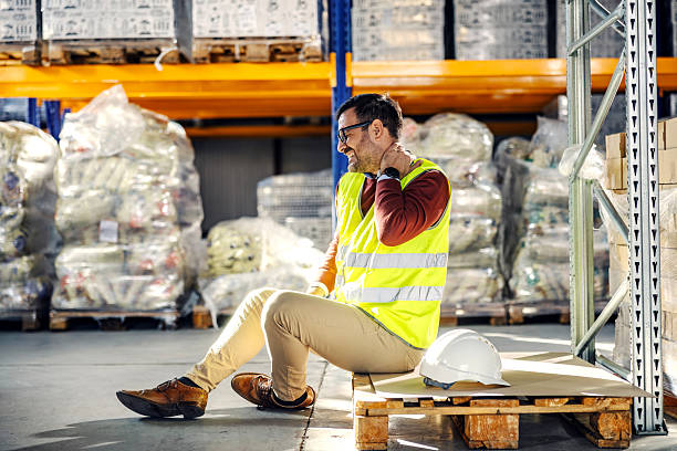 istock Warehouse worker suffering neck pain due to work injury 2245892508