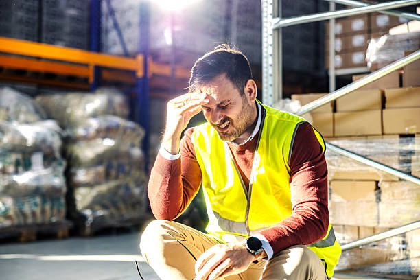 istock Stressed warehouse worker experiencing headache and exhaustion 2245892516