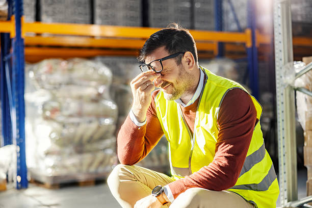 istock Overworked warehouse worker suffering from headache and stress 2245892518