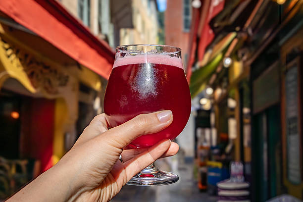 istock Raspberry lambic ale, old blurred buildings in background, Old Town Nice, France 2245897556