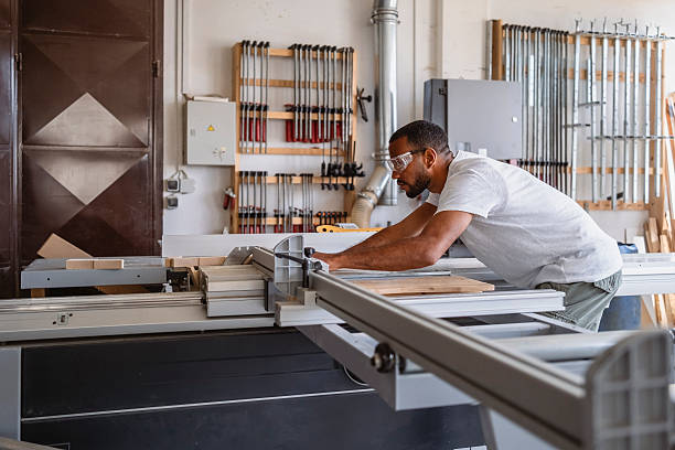 istock Focused Mid Adult Male Carpenter Working on Wood Using a Table Saw in a Bright Workshop 2245907706