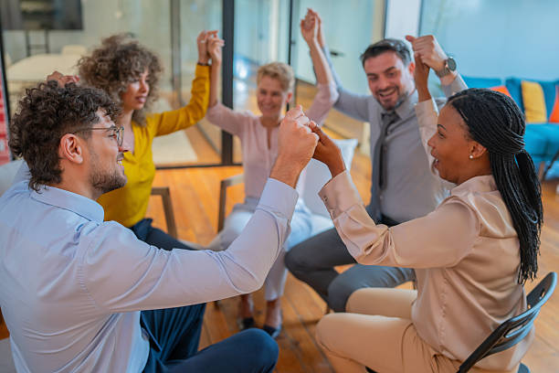 istock Business team joining hands celebrating success in office 2245907956