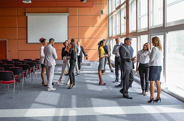 istock Diverse Business Executives Interacting at a Conference in Bright Room 2245909311