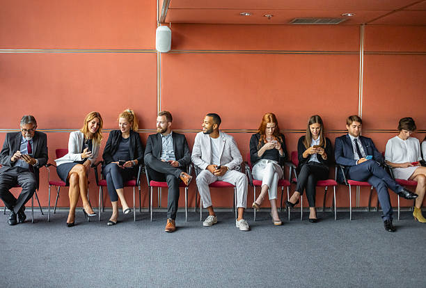 istock Diverse Business Executives Waiting for Conference to Begin in Modern Venue 2245909312