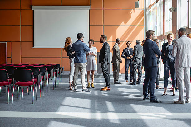 istock Diverse Executives Networking at Business Conference in Sunlit Room 2245909313