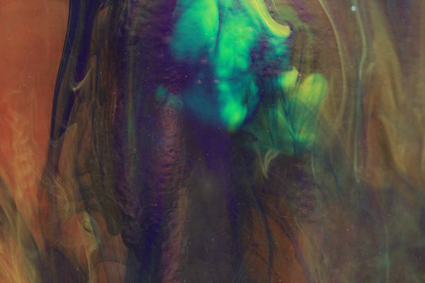 Inks and paints in water make a flowing art piece.