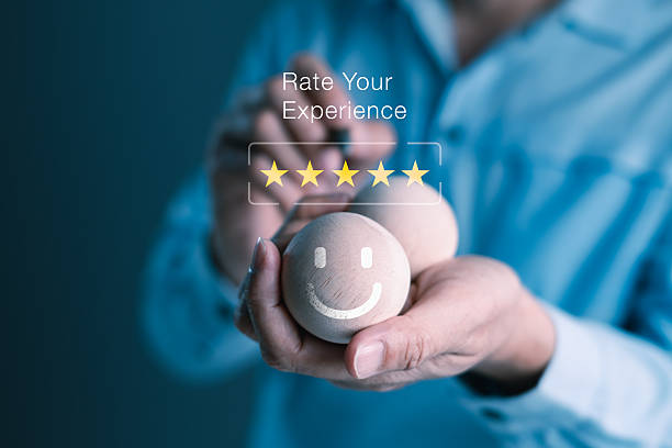 istock Customer holding wooden smiley face ball while giving five-star rating on digital feedback screen for service satisfaction and positive user experience concept 2245911403