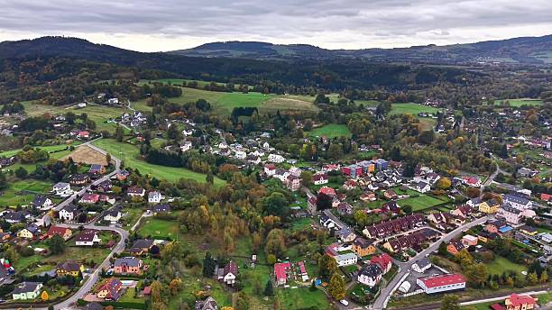 istock town above valley, scenic aerial view of town surrounded by patchwork fields and distant cloudy 2245911651