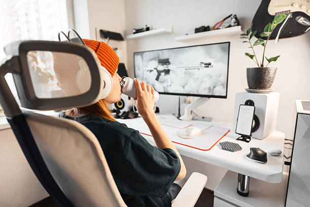 istock Focused young gamer drinks energy drink during esports session. Boosts concentration and performance while playing competitive video games at stylish home setup. Lifestyle of modern cybersport players 2245912862