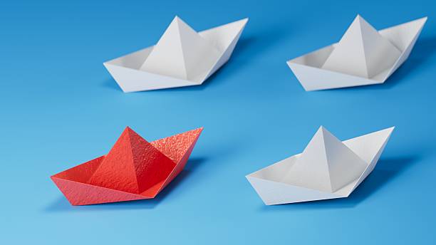 istock New ideas creativity and different innovative solution. Business concept. A group of paper ships, one boat is flying in the other direction, different way. 2245915232