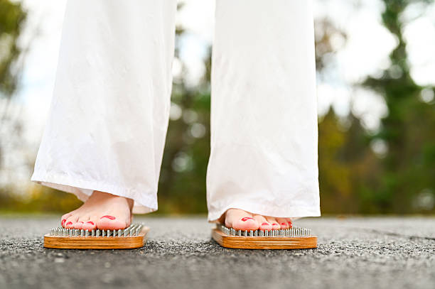 istock Woman practicing yoga standing on sadhu board 2245917224