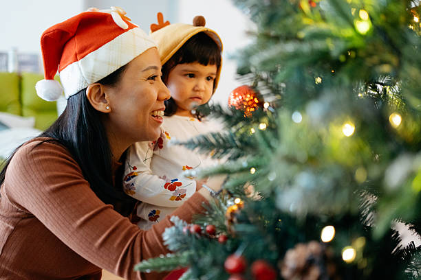 istock Happy Family Moment Decorating Christmas Tree 2245921736